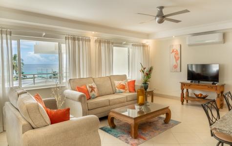 Beachfront Holiday Rental Barbados Palm Beach 410 Living Room with Couches, TV and Aircondition